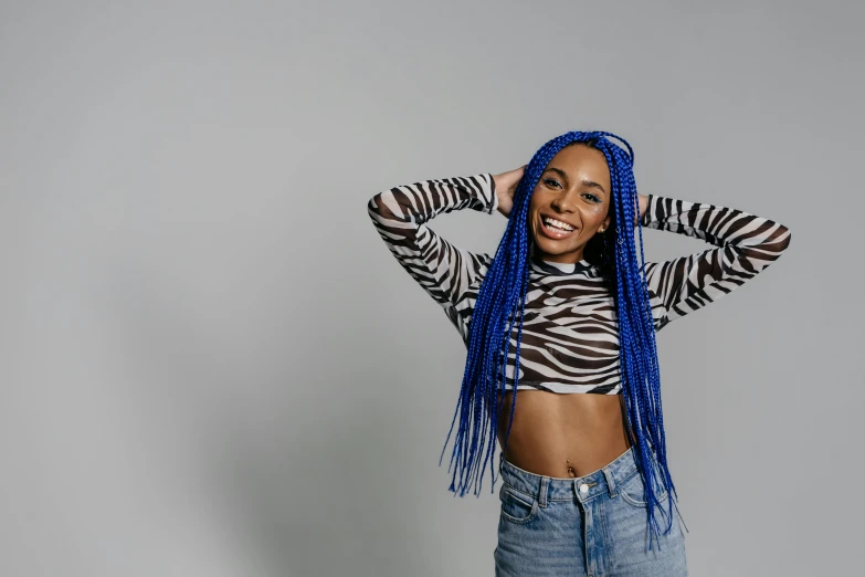 a woman with blue dreadlocks posing for a picture, trending on pexels, vanessa morgan, 15081959 21121991 01012000 4k, blue pants, smiling playfully