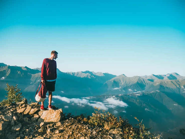 a man standing on top of a rocky mountain, pexels contest winner, avatar image, whistler, gazing off into the horizon, high quality product image”