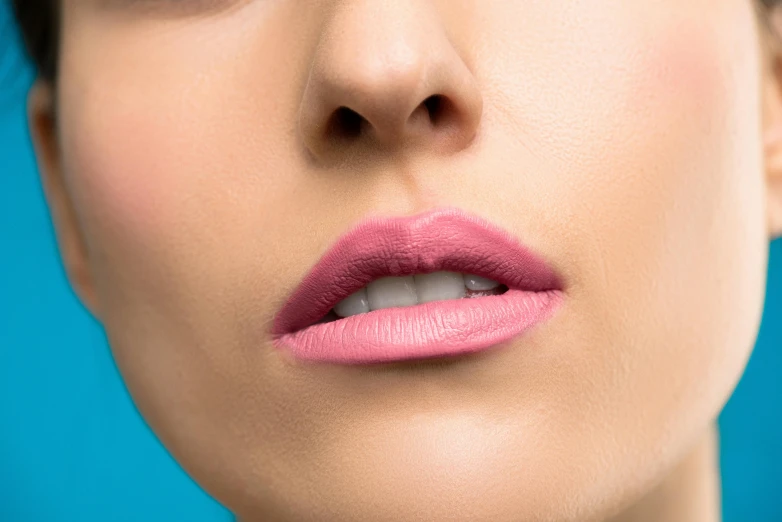 a close up of a woman with a pink lip, soft blue and pink tints, product shot, modelling, pink