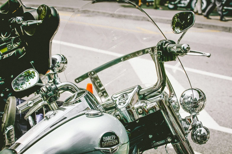 a close up of a motorcycle parked on the side of the road, by Carey Morris, pexels contest winner, 🚿🗝📝, glass visor, manly, stainless steel