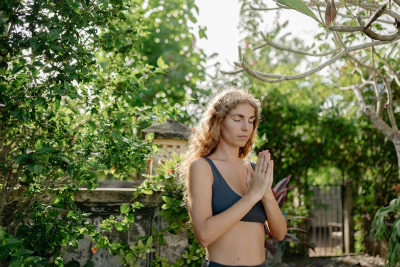 a woman in a bikini doing yoga outside, a portrait, unsplash, in garden, avatar image, doing a prayer, portrait image