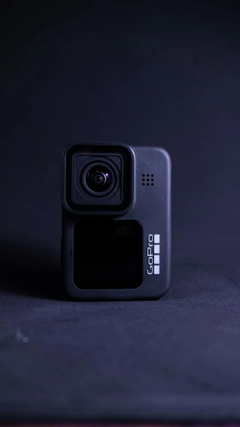 a small camera sitting on top of a table, a picture, shot on gopro9, on a flat color black background, game cover, wide angle exterior 2022