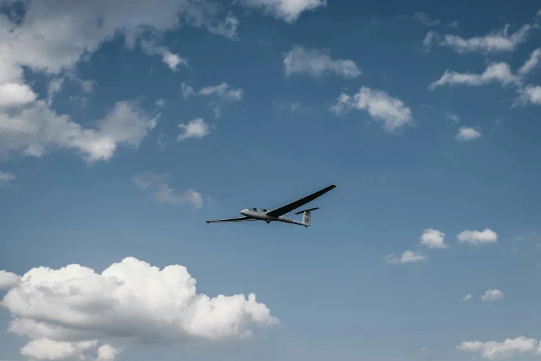 a small airplane flying through a cloudy blue sky, unsplash, hurufiyya, robotic drones, cessna glider plane, thumbnail, high res 8k