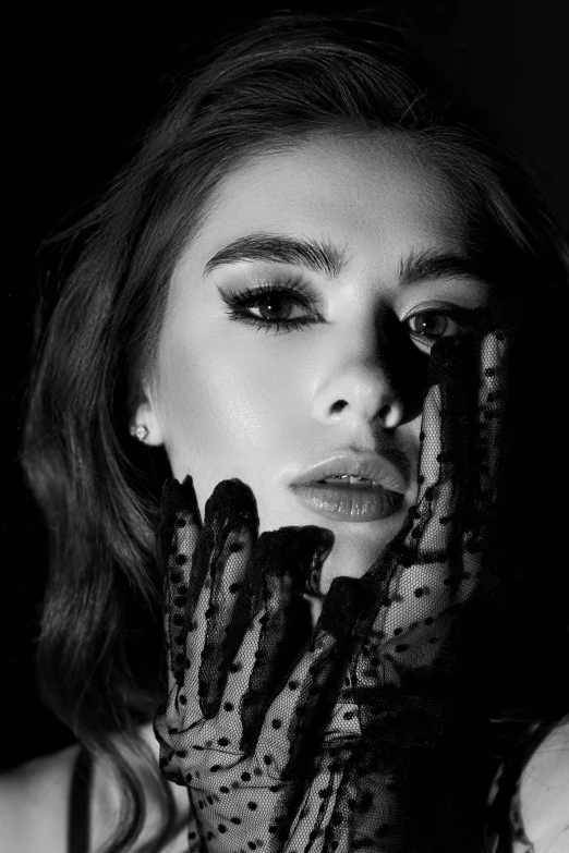 a woman holding her hands up to her face, a black and white photo, inspired by Marie-Gabrielle Capet, lilly collins, grimes - book 1 album cover, black gloves, madison beer girl portrait