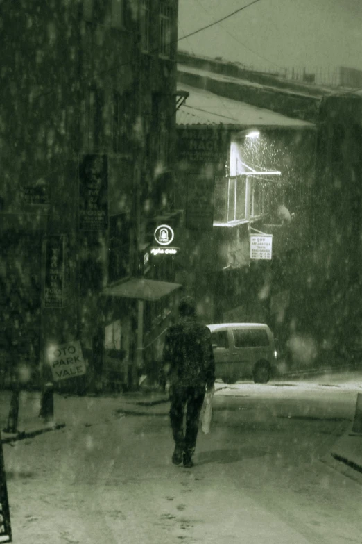 a person walking in the snow with an umbrella, inspired by Hasui Kawase, shin hanga, dark photograph, green light, 3 pm, street photograph