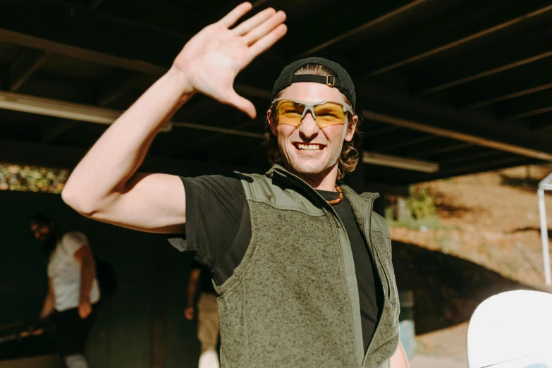 a man that is holding a snowboard in his hand, by Carey Morris, pexels contest winner, wearing an eyepatch, joe keery, waving hands, structure : kyle lambert