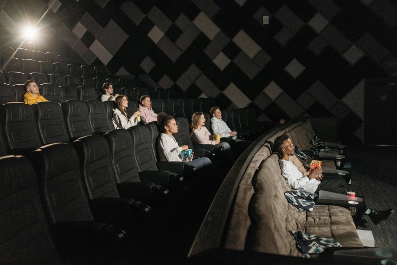 a group of people sitting in a movie theater