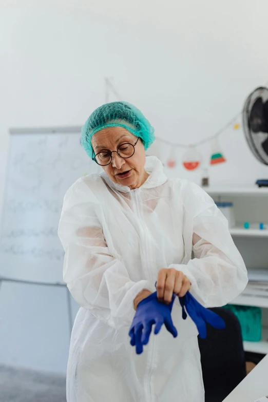 a woman in a white lab coat and blue gloves, pexels contest winner, plastic and fabric, grandma, teaching, clean room