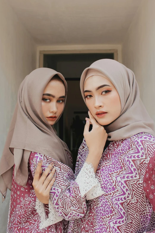 a couple of women standing next to each other, a picture, by Basuki Abdullah, shutterstock, hurufiyya, square face, 🤤 girl portrait, taupe, female model