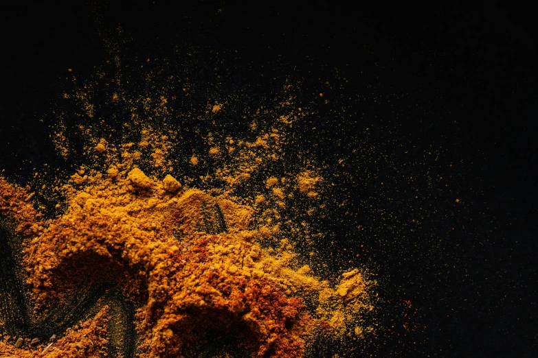 a pile of powder sitting on top of a table, trending on unsplash, hurufiyya, yellow-orange, dark, ultra intricate, spices