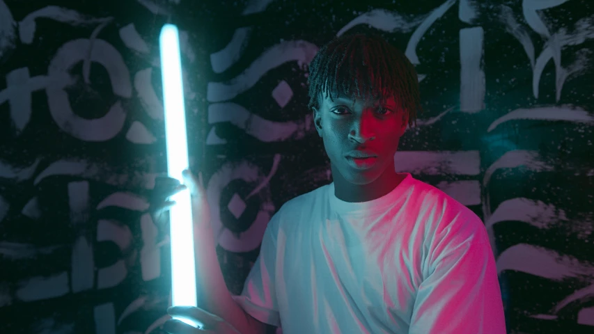 a man holding a light saber in front of a graffiti wall, pexels contest winner, afrofuturism, glowing lights!! sci-fi, black teenage boy, holding two swords, white neon lighting