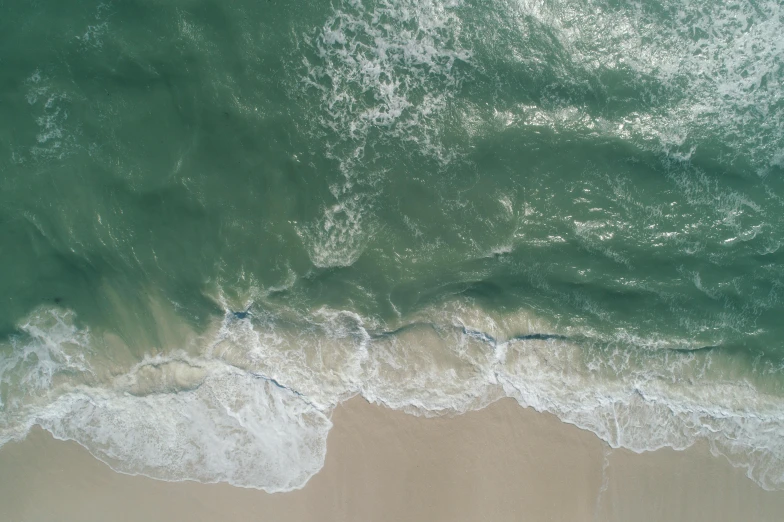 a person riding a surfboard on top of a sandy beach, pexels contest winner, renaissance, aerial footage, deep green, water texture, 4k —height 1024 —width 1024