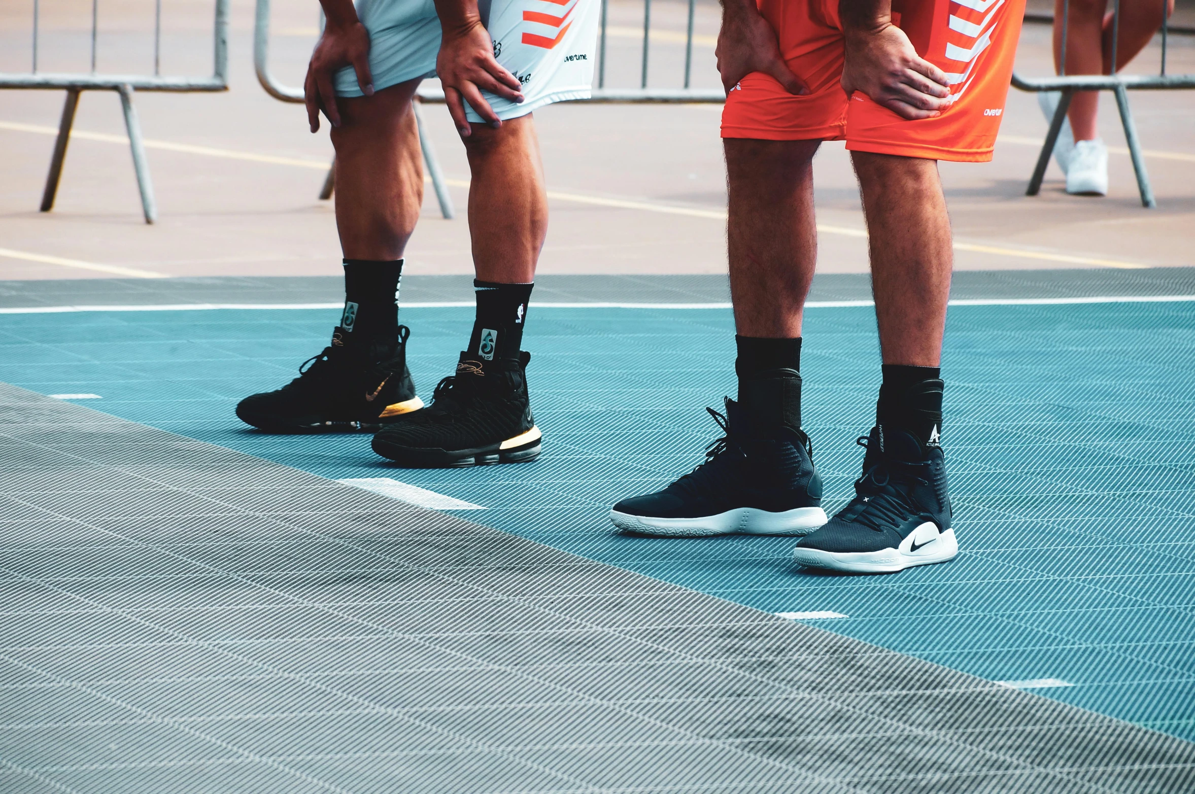 a couple of men standing next to each other on a court, trending on dribble, laces, squad, bottom angle, stacked