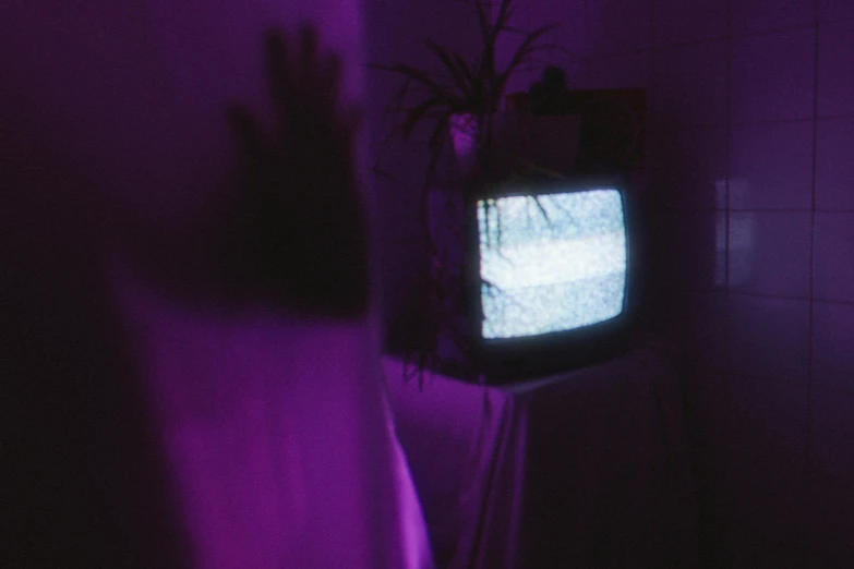 a television sitting on top of a stand in a room, an album cover, inspired by Elsa Bleda, unsplash, video art, purple alien, hands not visible, horror aesthetic, 8 0 ies aesthetic