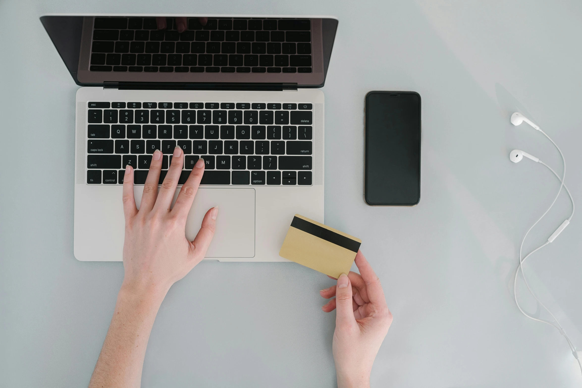 a person holding a credit card in front of a laptop, trending on pexels, flatlay, instagram post, plain background, gold