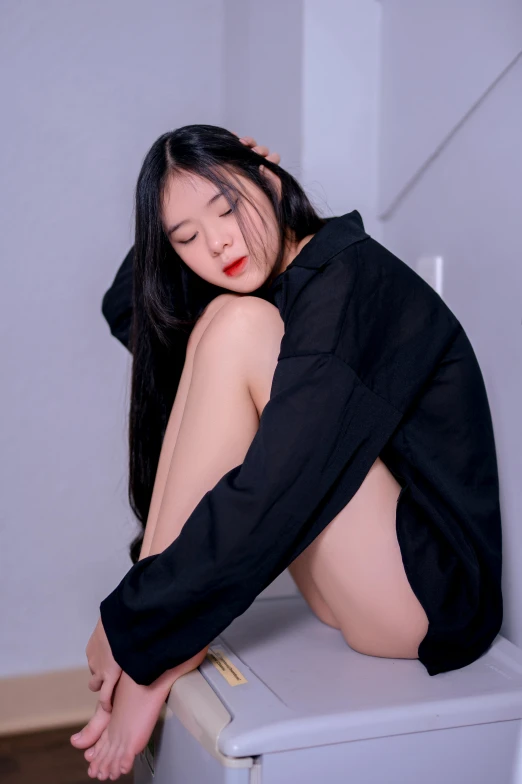 a woman sitting on top of a refrigerator, an album cover, by Yu Zhiding, realism, long thin black hair, casual black clothing, yanjun chengt, exposed thighs