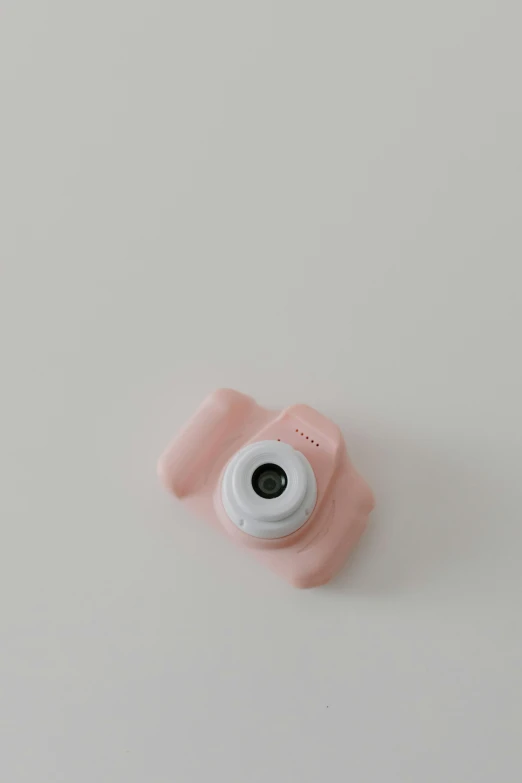 a pink camera sitting on top of a white table, soft shapes, child, detailed product image, damaged webcam image