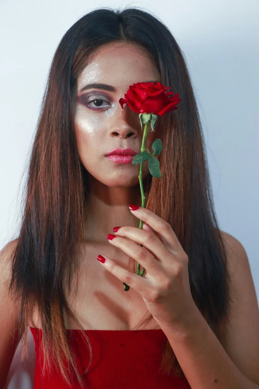 a woman in a red dress holding a rose, an album cover, inspired by Elsa Bleda, pexels contest winner, indian girl with brown skin, 👅 👅, pose 4 of 1 6, chaos beauty