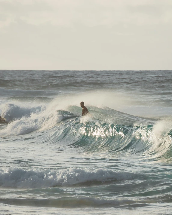 a man riding a wave on top of a surfboard, by Jessie Algie, pexels contest winner, two male, waikiki beach, no cropping, barrel chested