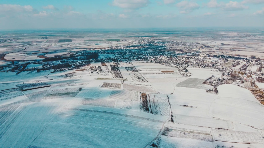 an aerial view of a snow covered landscape, by Daniel Lieske, pexels contest winner, visual art, soviet suburbs, background image, low quality footage, northern france