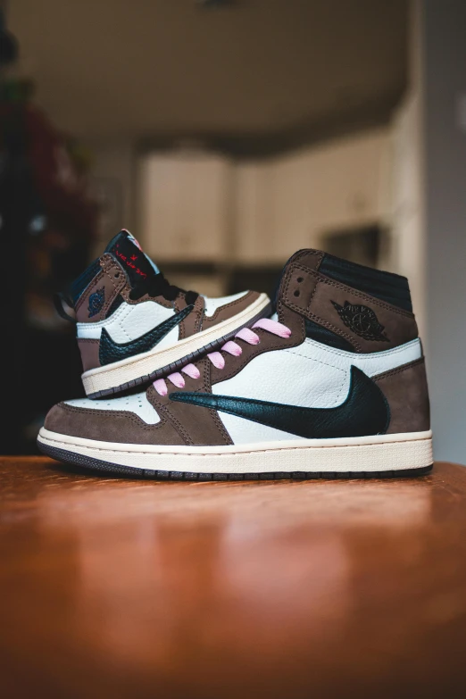 a pair of sneakers sitting on top of a wooden table, inspired by Jordan Grimmer, brown and pink color scheme, air jordan 1 high, ebay listing thumbnail, profile shot