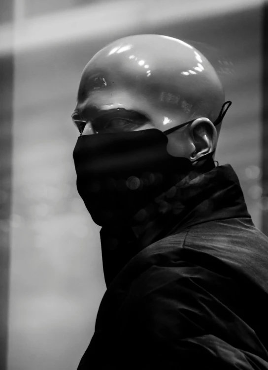 a black and white photo of a man wearing a mask, by Adam Marczyński, bald, 1 0 % cyberpunk, profile picture, avatar image