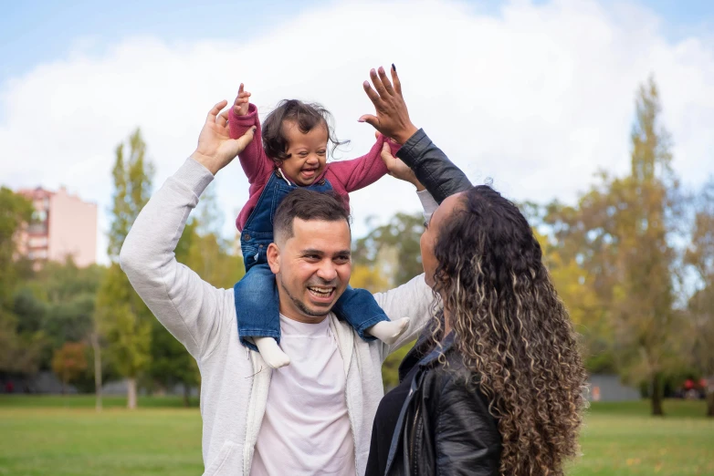 a man holding a little girl on his shoulders, pexels contest winner, hurufiyya, of a family standing in a park, manuka, waving and smiling, square