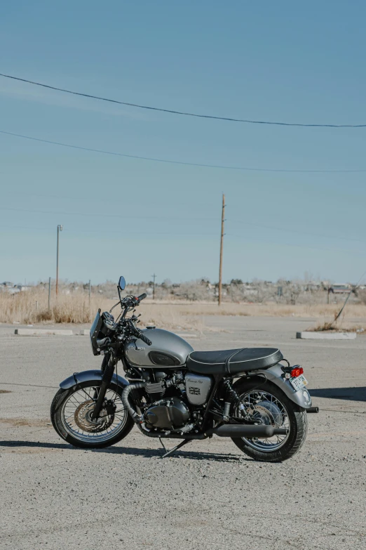 a motorcycle parked on the side of the road, triumph, profile image, albuquerque, unsplash photography