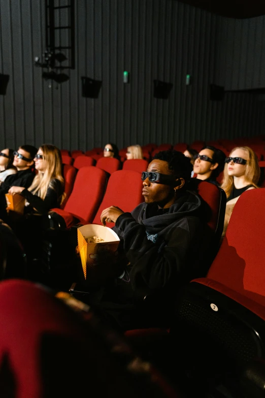 a group of people sitting in a movie theater