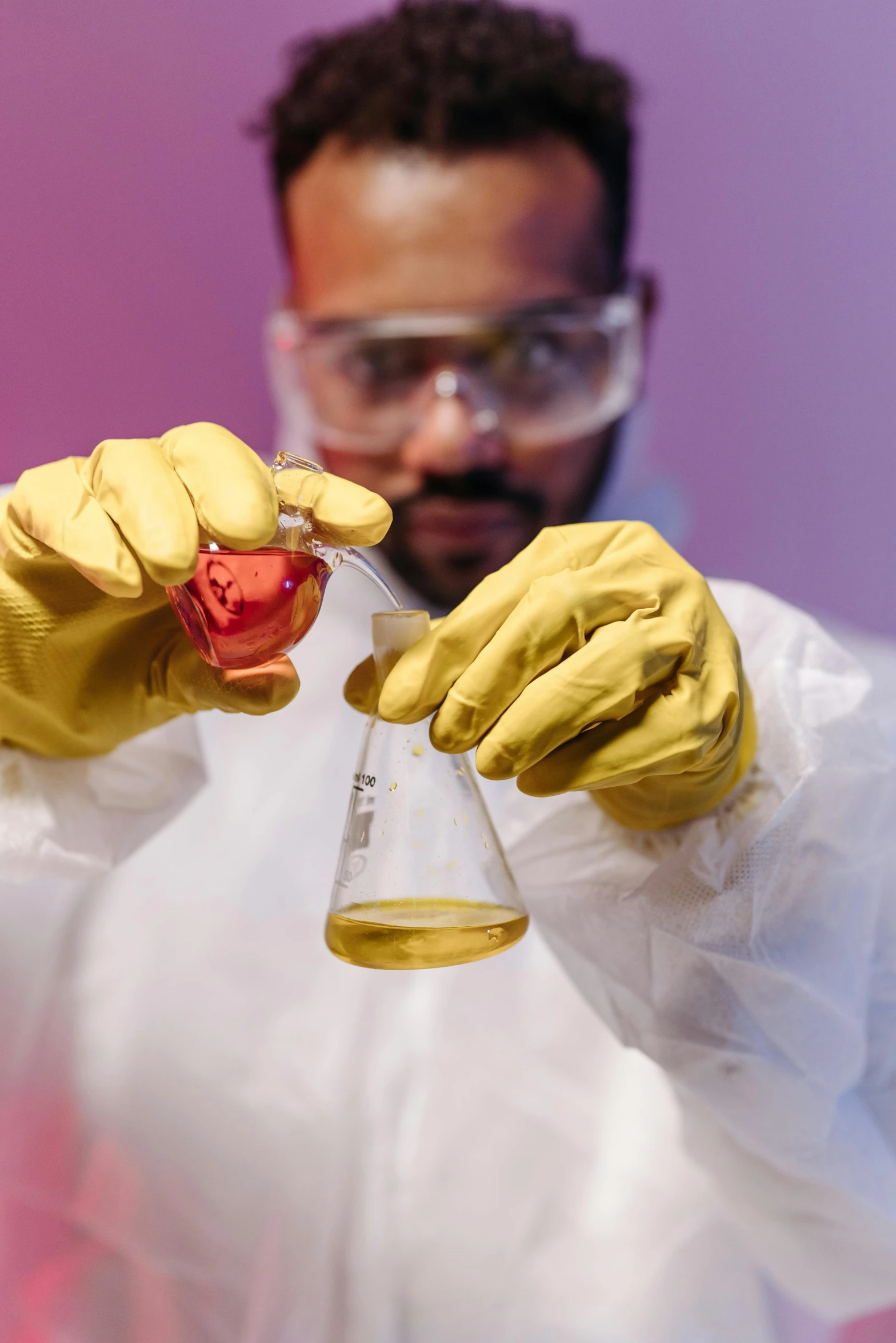 a man in a lab coat holding a flask, an album cover, shutterstock, synthetism, yellow latex gloves, 2019 trending photo, nanotechnology, red liquid