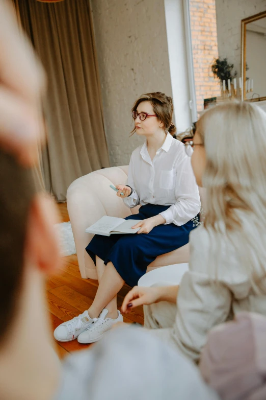 a group of people sitting on a couch in a living room, by Adam Marczyński, trending on pexels, wearing a suit and glasses, woman is sitting, dialogue, religious