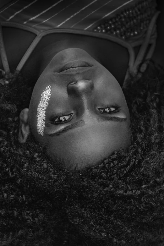 a man laying on top of a rug next to a tennis racquet, a black and white photo, inspired by Carrie Mae Weems, pexels contest winner, afrofuturism, girl with plaits, close up face portrait, eyes with catchlight, black teenage girl