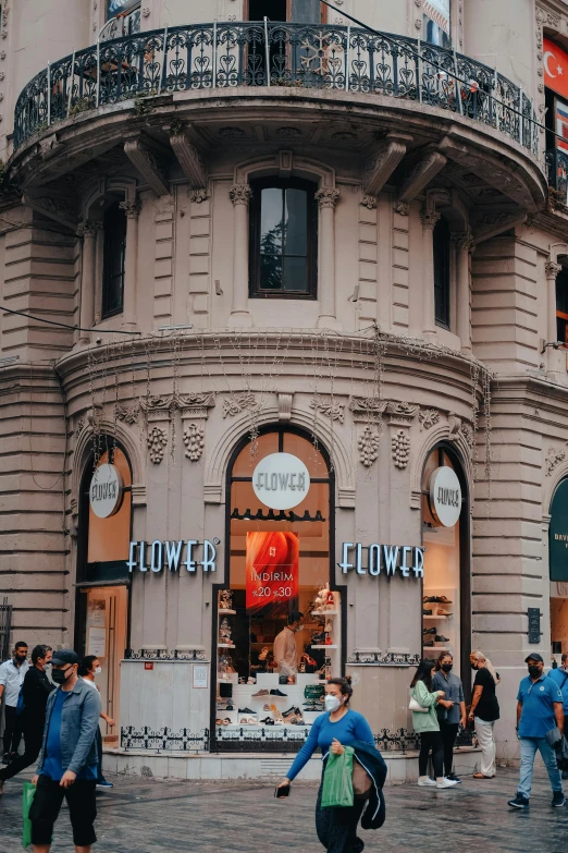 a group of people walking in front of a building, pexels contest winner, art nouveau, flower shop scene, buenos aires, tower, promotional image