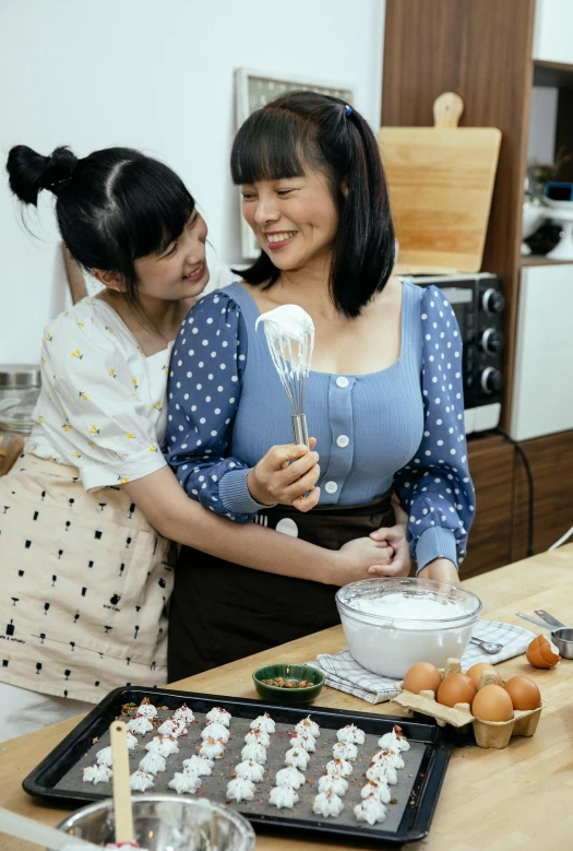 a couple of women standing next to each other in a kitchen, inspired by Cui Bai, pexels contest winner, dau-al-set, puff sleeves, asian, whipped cream on top, good housekeeping