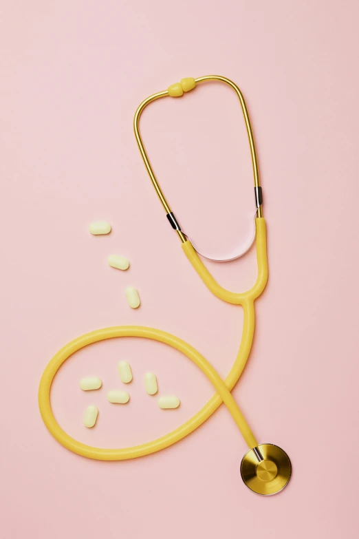 a stethoscope and pills on a pink background, by Carey Morris, yellow aureole, hero shot, schools, vanilla