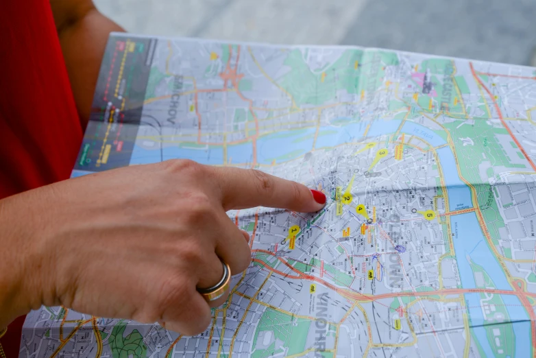 a close up of a person holding a map, by Julia Pishtar, pexels contest winner, hyperrealism, budapest, national geographics, summer evening