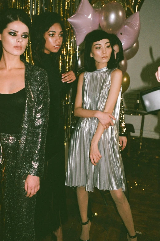 a group of women standing next to each other, inspired by Tadashi Nakayama, trending on pexels, renaissance, disco party, coated pleats, silver light, kiko mizuhara