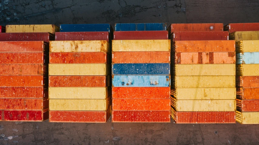 a group of containers stacked on top of each other, inspired by Donald Judd, unsplash, red yellow blue, shipping docks, “ iron bark, cardistry