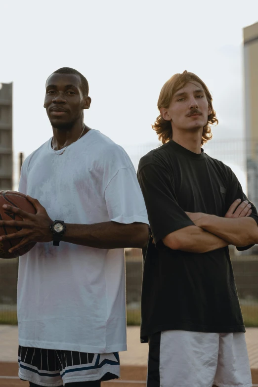 two men standing next to each other on a basketball court, by Carey Morris, trending on dribble, mrbeast, nfl, b - roll, with towers