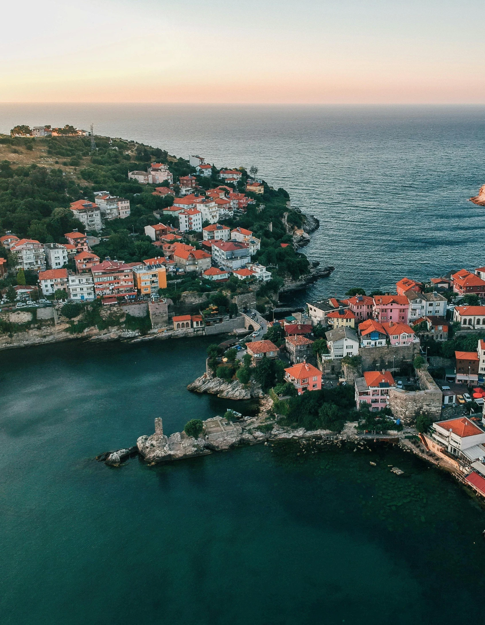 a small town in the middle of a body of water, black sea, profile image, lush surroundings, flatlay