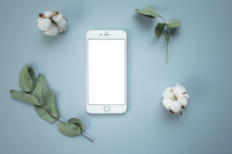 a white cell phone sitting on top of a table, trending on pexels, cotton, eucalyptus, avatar image, various posed