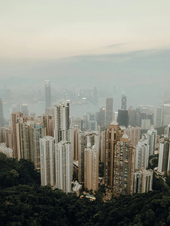 a view of a city from the top of a mountain, by Patrick Ching, pexels contest winner, high rise skyscrapers, slightly pixelated, low quality photo, background image