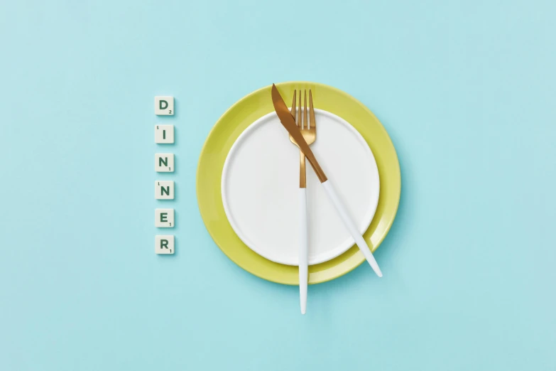 a close up of a plate with a fork and a knife, an album cover, inspired by Cerith Wyn Evans, trending on pexels, dau-al-set, funny jumbled letters, sea green color theme, background image, diner food