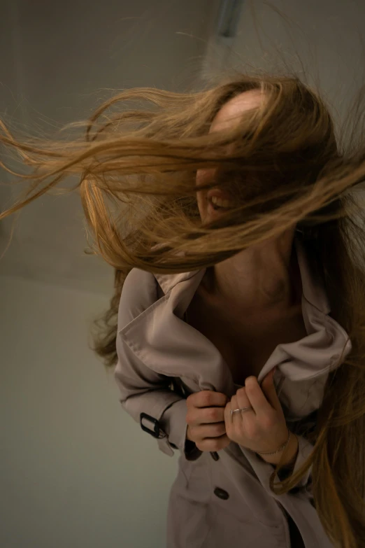 a woman with her hair blowing in the wind, an album cover, inspired by Anna Füssli, pexels contest winner, hyperrealism, indoor picture, light brown hair, captures emotion and movement, furr covering her chest