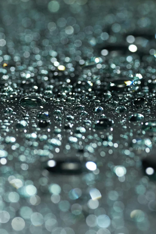 a close up of water droplets on a surface, by Jan Rustem, shiny materials, atmospheric crystal dust