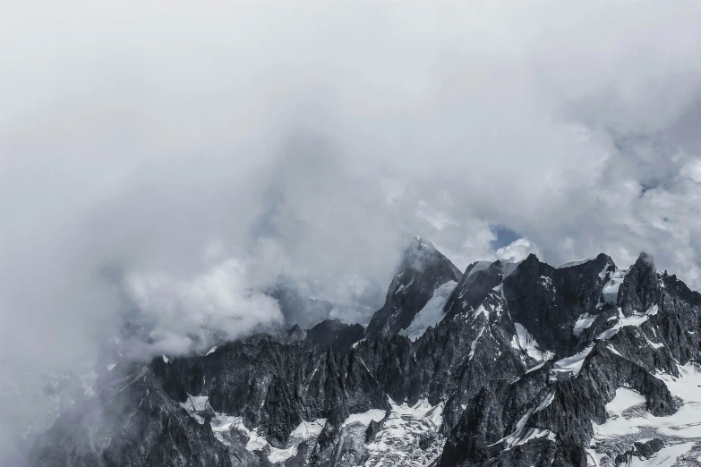 a group of people standing on top of a snow covered mountain, an album cover, pexels contest winner, grey clouds, 4 k hd wallpapear, panoramic shot, chamonix