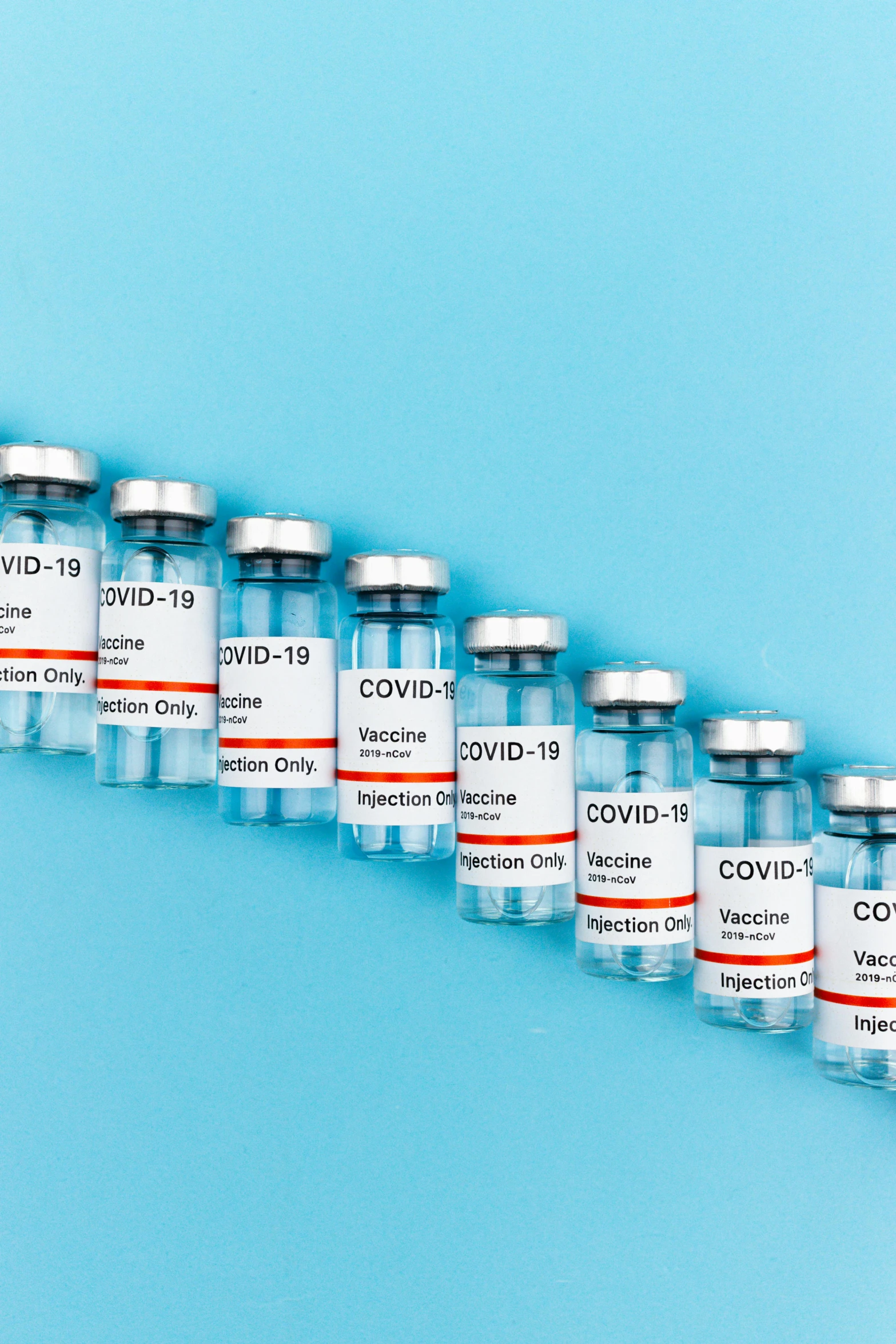 a row of vials sitting on top of a blue surface, instagram post, medical labels, covid, the