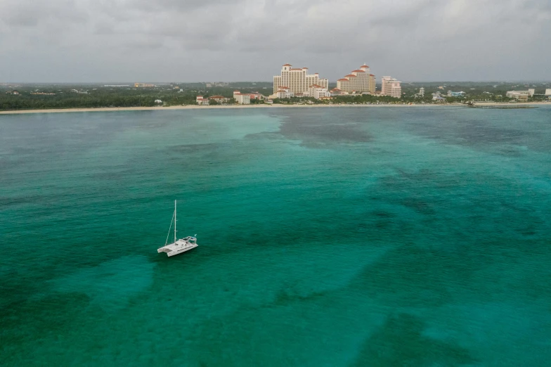 a boat in the middle of a large body of water, by Ryan Pancoast, pexels contest winner, bahamas, atlantis city, slight overcast, f / 2 0