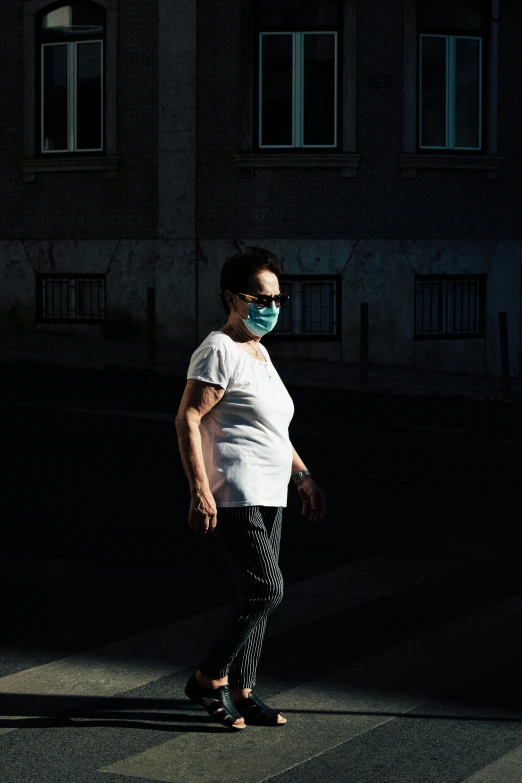 a woman riding a skateboard down a street, by Tobias Stimmer, medical mask, back light contrast, caretaker, liang mark