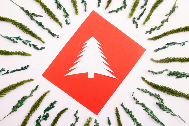 a red square with a white christmas tree on it, an album cover, inspired by Ernest William Christmas, pexels contest winner, folk art, evergreen branches, paper craft, thumbnail, 3/4 view from below